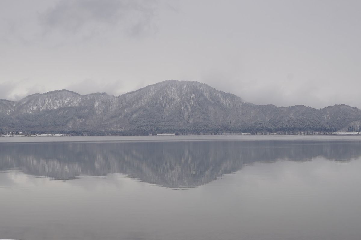 今日は雪が降っている田沢湖。
湖面に映る山が美しい。